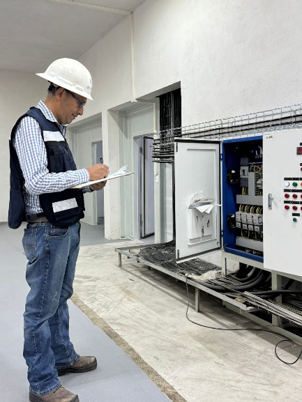 Technician inspecting an industrial electrical installation
